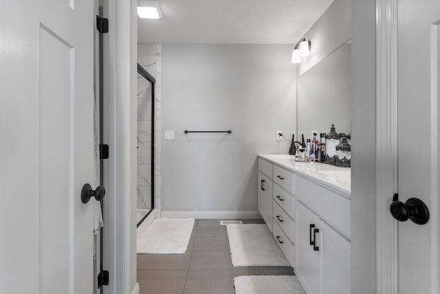 bathroom with walk in shower, tile patterned floors, and vanity