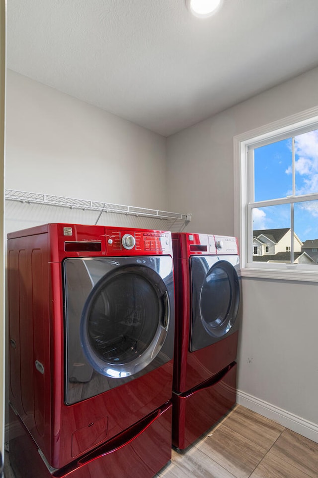 507 Wheatley Dr, Mahomet, IL 61853 - laundry room featuring washing machine and clothes dryer, baseboards, laundry area, and wood finished floors