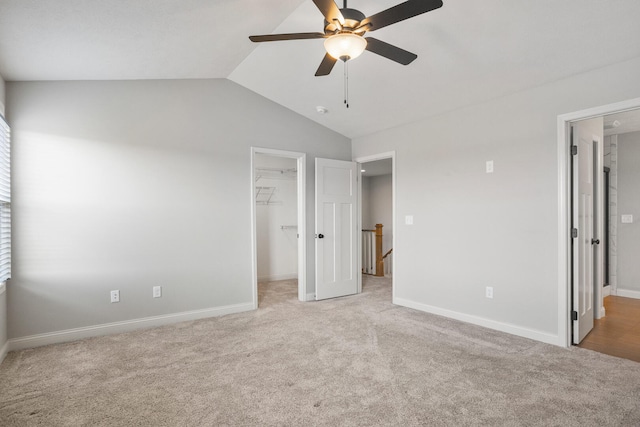 507 Wheatley Dr, Mahomet, IL 61853 - unfurnished bedroom featuring vaulted ceiling, a spacious closet, and light colored carpet