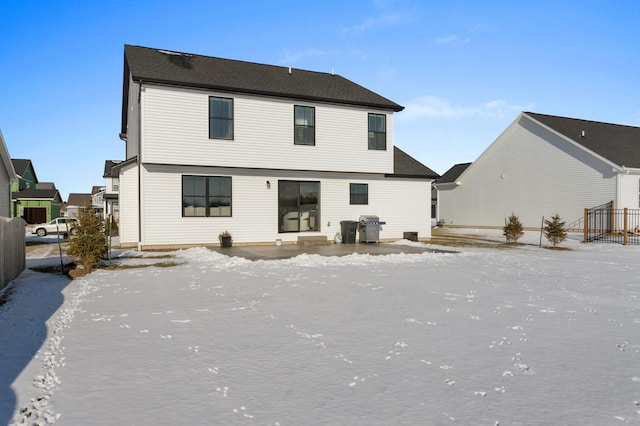 view of snow covered back of property