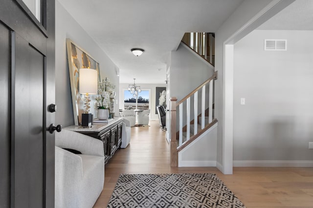 entrance foyer featuring a notable chandelier and hardwood / wood-style floors