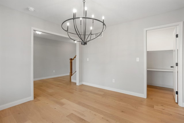 507 Wheatley Dr, Mahomet, IL 61853 - unfurnished dining area featuring an inviting chandelier, baseboards, and light wood finished floors