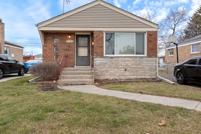 bungalow-style home featuring a front lawn