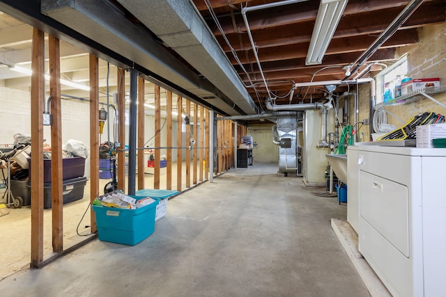 basement with washer / dryer and heating unit