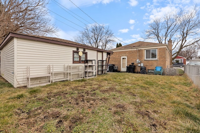 rear view of house with a yard