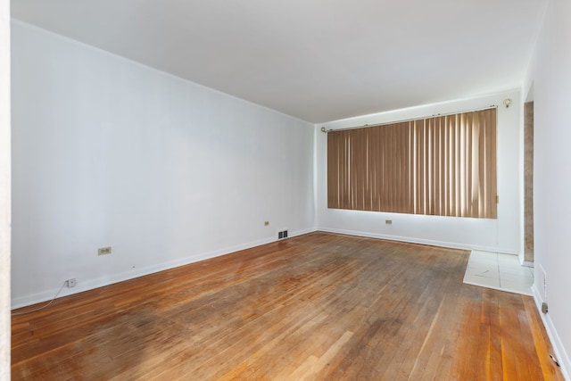 spare room featuring wood-type flooring