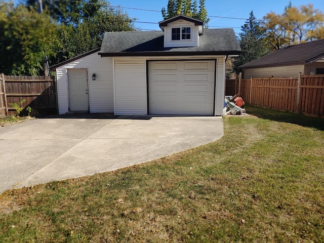 garage featuring a lawn