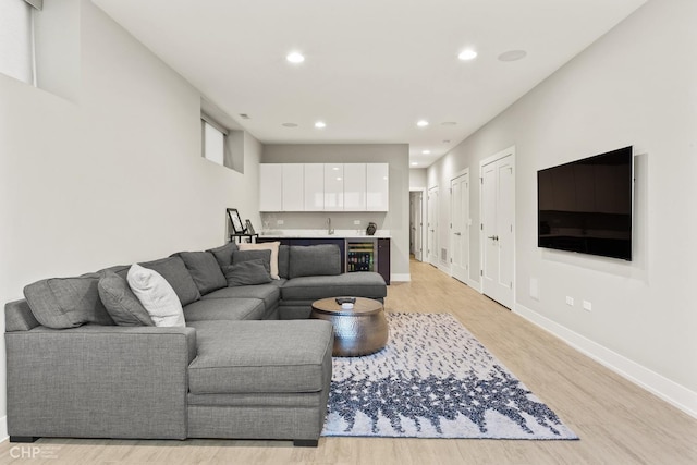 living room featuring light wood-type flooring and sink