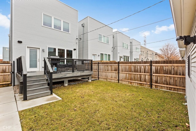 back of property featuring a lawn and a deck