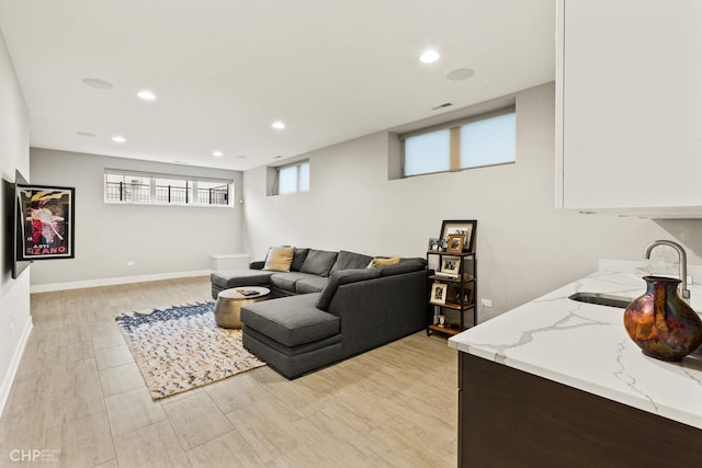 living room featuring light hardwood / wood-style flooring and sink