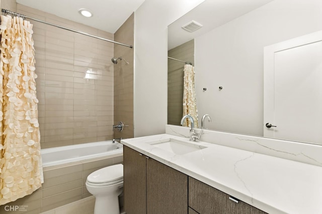 full bathroom featuring shower / bath combination with curtain, toilet, and vanity