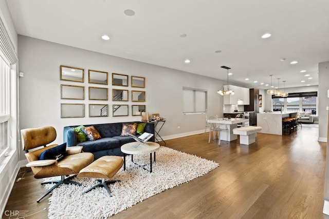 living room featuring dark hardwood / wood-style floors and an inviting chandelier