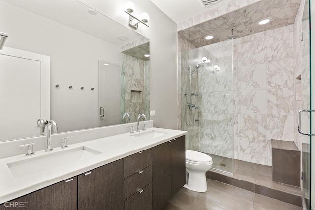 bathroom featuring tile patterned flooring, vanity, and a shower with shower door