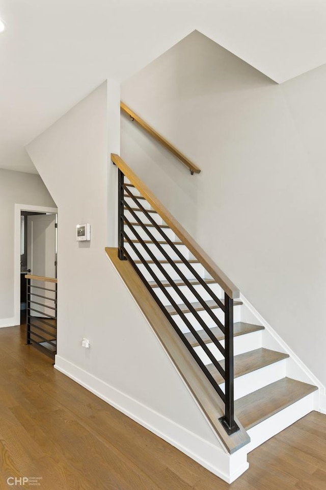 staircase with hardwood / wood-style floors