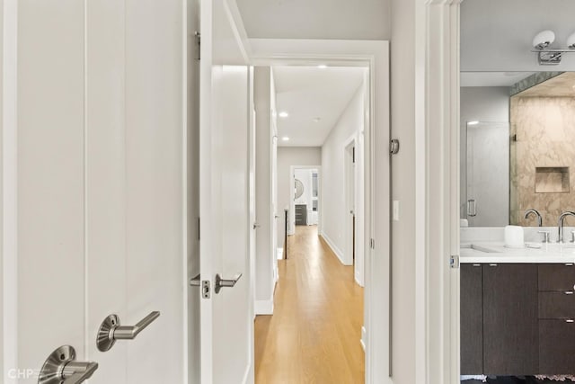 corridor with light hardwood / wood-style floors