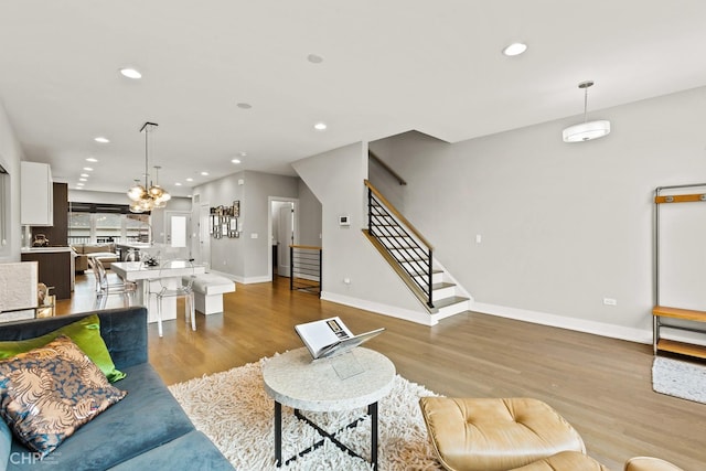 living room featuring light hardwood / wood-style floors and an inviting chandelier