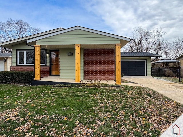 ranch-style house with a front lawn, covered porch, and a garage