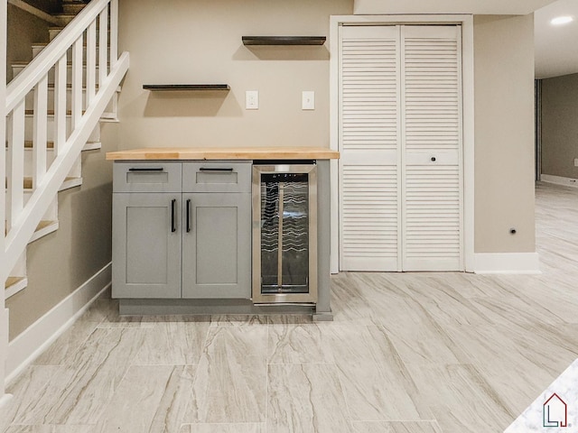 bar with gray cabinets, butcher block counters, and wine cooler