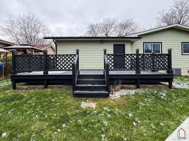 back of house featuring a gazebo, a deck, and a yard