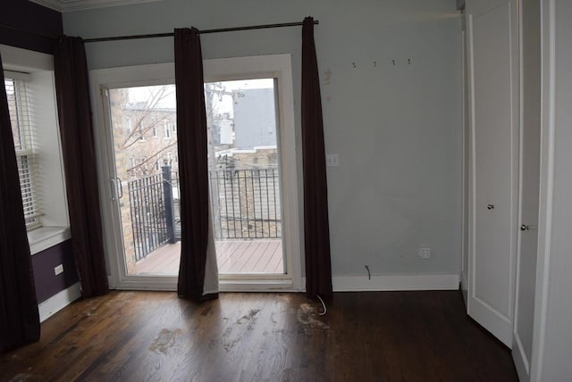 interior space with crown molding and dark wood-type flooring