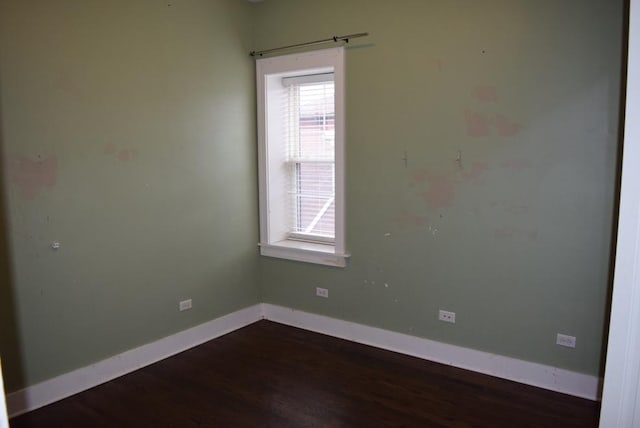 empty room featuring dark wood-type flooring