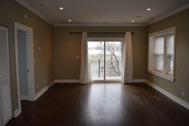 empty room with dark hardwood / wood-style floors and ornamental molding