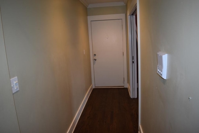 corridor with ornamental molding and dark wood-type flooring