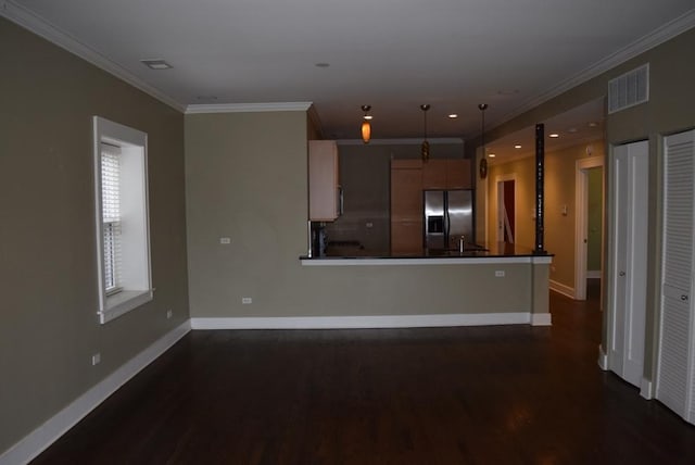 kitchen with pendant lighting, stainless steel fridge, kitchen peninsula, and ornamental molding