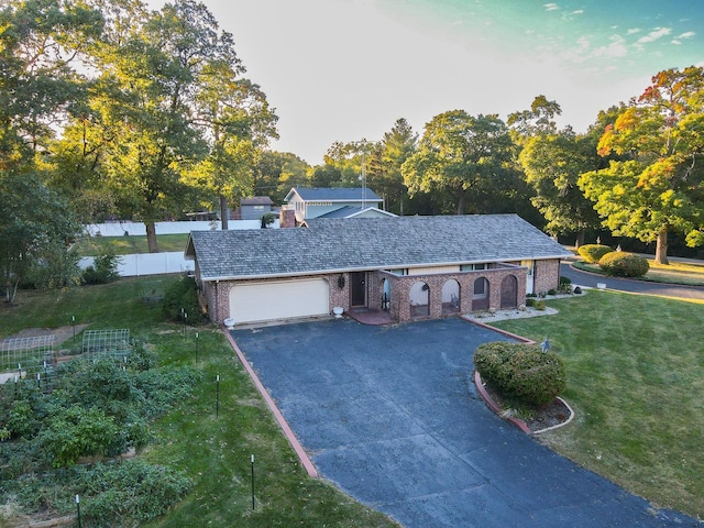 view of front of property with a front yard and a garage