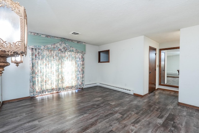 empty room featuring a baseboard radiator and dark hardwood / wood-style floors