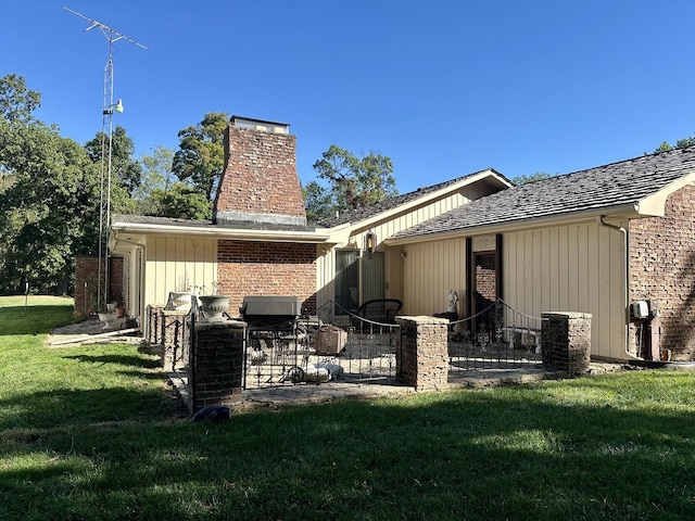 rear view of house featuring a yard