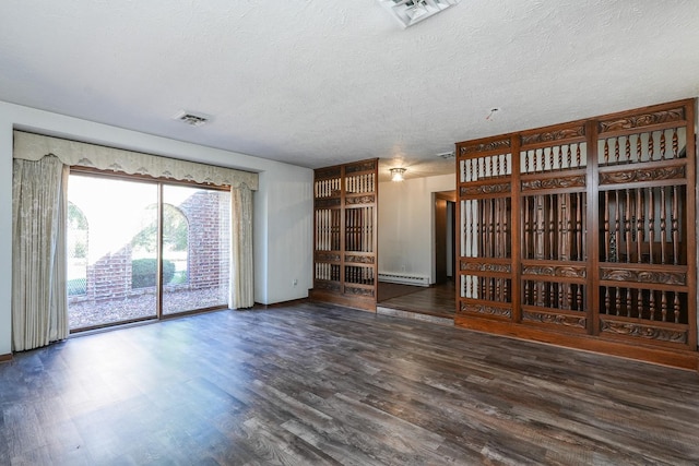 unfurnished living room with dark hardwood / wood-style flooring, a textured ceiling, and a baseboard radiator