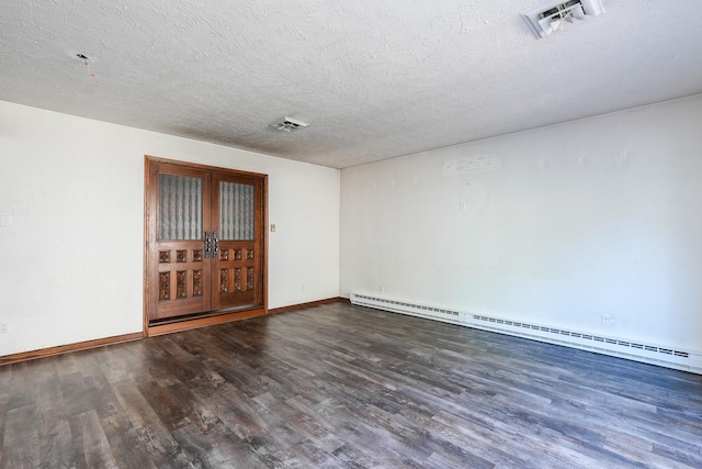 empty room with dark wood-type flooring, french doors, a baseboard radiator, and a textured ceiling