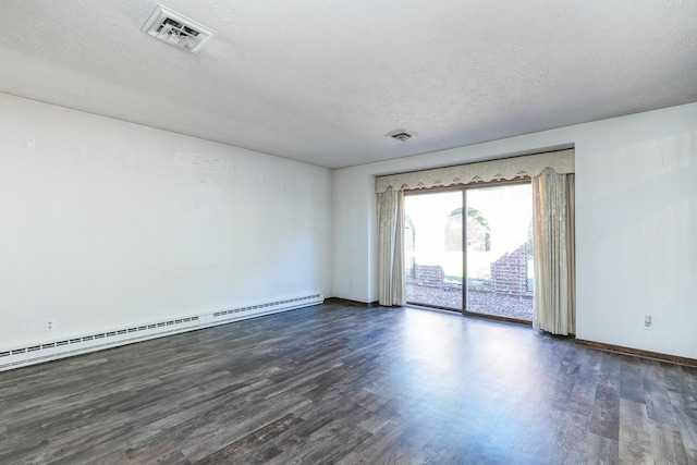 unfurnished room with dark hardwood / wood-style floors, a textured ceiling, and a baseboard heating unit