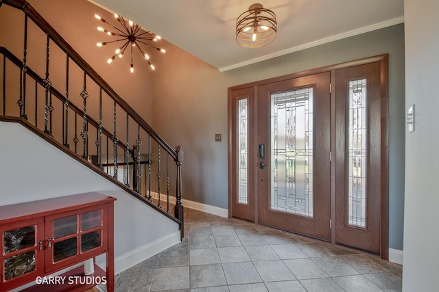 entryway featuring tile patterned floors, a notable chandelier, and crown molding