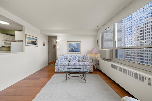 living room with radiator heating unit and hardwood / wood-style flooring