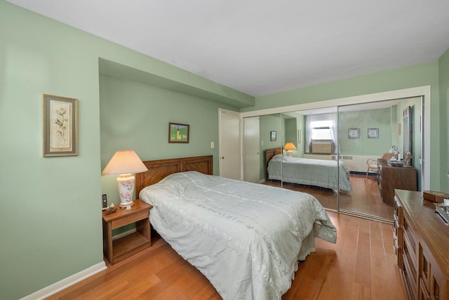 bedroom with a closet and light hardwood / wood-style flooring