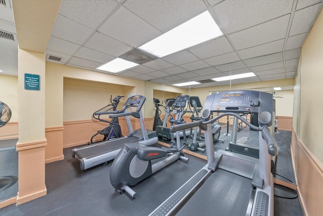 exercise room with a paneled ceiling