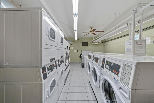 washroom featuring light tile patterned floors, stacked washer and dryer, washer and clothes dryer, and ceiling fan