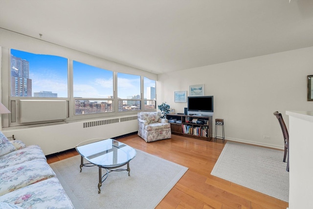 living room with light hardwood / wood-style flooring and radiator