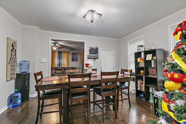 dining space featuring ceiling fan, ornamental molding, and dark wood-type flooring