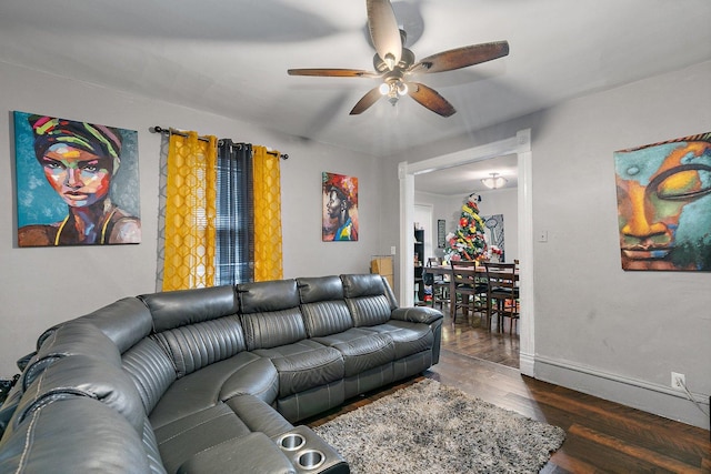 living room featuring dark hardwood / wood-style flooring and ceiling fan