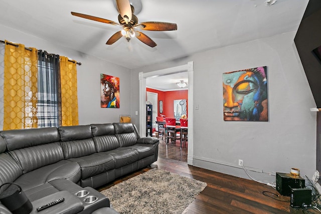 living room featuring ceiling fan and dark wood-type flooring