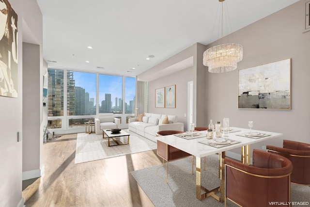 dining room featuring hardwood / wood-style floors, a notable chandelier, and expansive windows