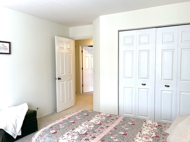 bedroom with light colored carpet and a closet