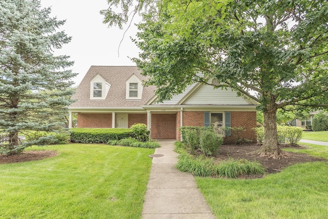 new england style home featuring a front yard