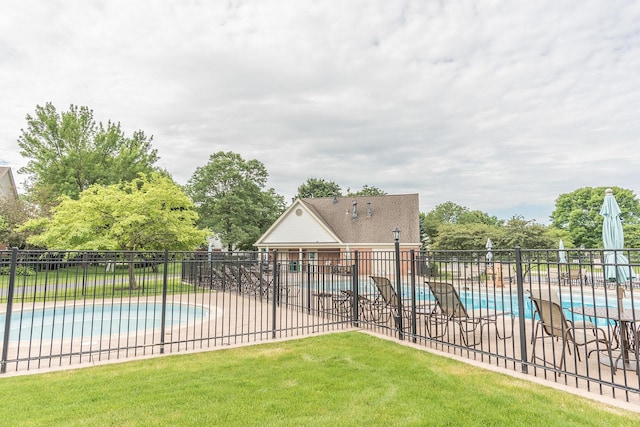 view of pool featuring a yard and a patio