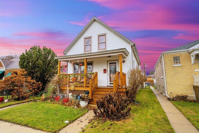 view of front facade featuring a yard and covered porch