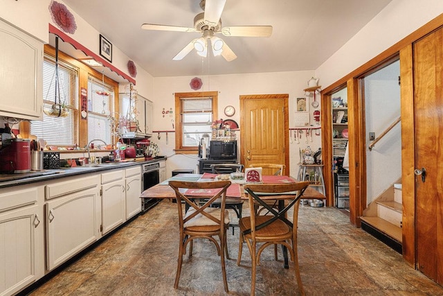 kitchen featuring ceiling fan, black dishwasher, and sink