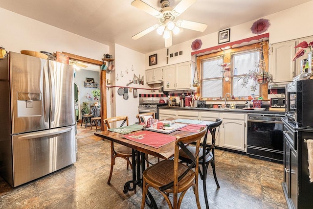 kitchen featuring ceiling fan, sink, white cabinetry, and stainless steel appliances